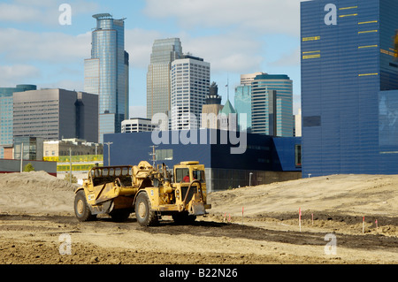 Construction equipment at work in an area being redeveloped in Minneapolis Minnesota Minneapolis skyline and Gutherie Theatre