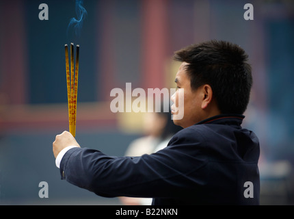A Local Man With Burning Incense Sticks Lama Temple Yonghegong Beijing China Stock Photo