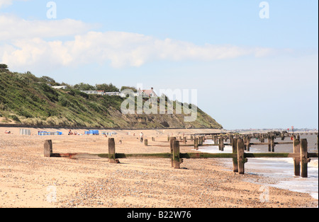 beach groynes cliffs and sunbathers Stock Photo