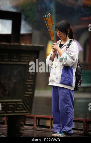 Girl With Burning Incense Sticks Lama Temple Yonghegong Beijing China Stock Photo