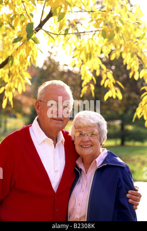 Portrait of senior couple smiling in park Stock Photo