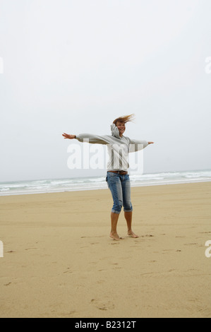 Woman stretching her arms on beach Stock Photo