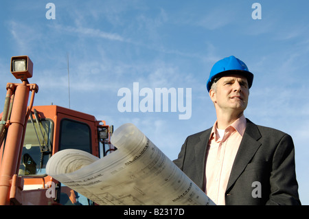 Male architect holding blueprints Stock Photo