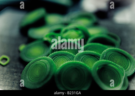 Sliced leeks on a wooden chopping board Stock Photo