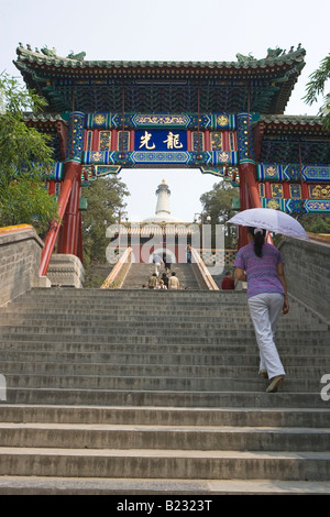 Group of people climbing stairs of pagoda White Dagoba Temple Beijing China