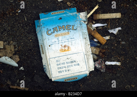 An empty pack of Camel light cigarettes is tossed away on the street The pack is for the Korean market Stock Photo