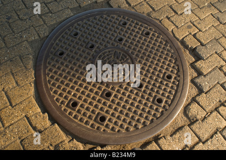 Close up of manhole cover on street Stock Photo