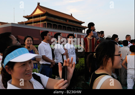Chinese tourists watch striking the flag in Tiananmen Square in Beijing China. 12 Jul 2008 Stock Photo
