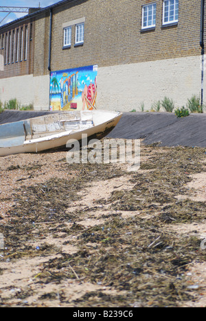 Boat seaweed tidal line and mural Stock Photo