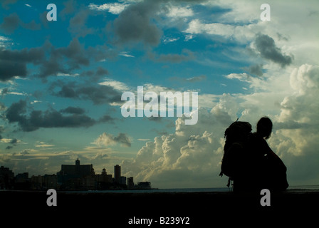 Silhouette of a packpaker looking at cloudscape in Havana, Cuba Stock Photo