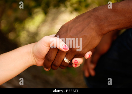 Interracial hand holding Stock Photo