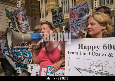 Protesters and card at London Keep our NHS Public demo on 60th anniversary of NHS outside Richmond House, Whitehall NHS HQ Stock Photo