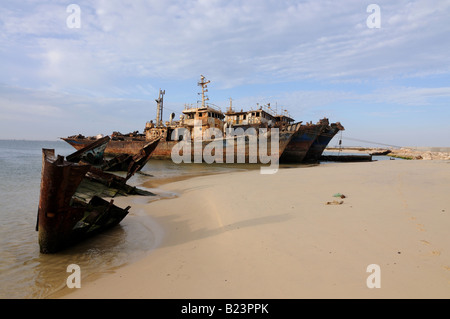 Ship wrecks rusting on the shores of the beach of Nouadhibou one of the largest ship wreck cemeteries worldwide Mauritania Stock Photo