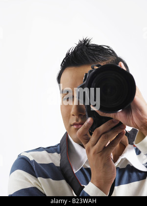 Young man taking photo with camera Stock Photo