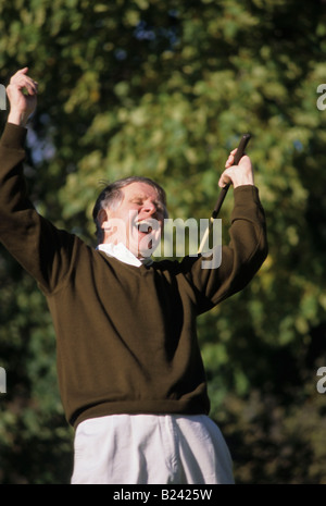 HEALTHY SENIOR MAN ON GOLF COURSE CELEBRATING SHOT Stock Photo