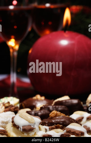 The Christmas cookies and wine poured into a wine glass burning one  red candle pictures images photos very high resolution vertical in USA US hi-res Stock Photo
