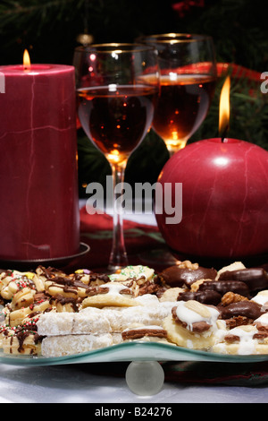 The Christmas cookies and wine poured into a wine glass burning two red candles pictures images photos very high resolution vertical in USA US hi-res Stock Photo