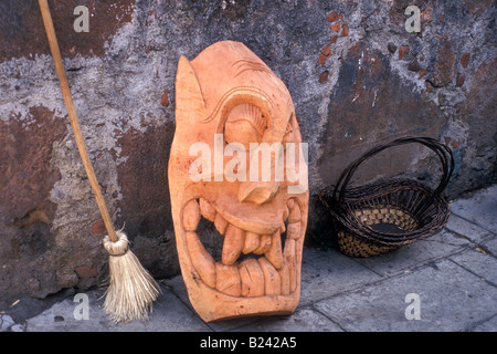 Grotesque wooden mask and straw broom in Patzcuaro, Michoacan, Mexico Stock Photo