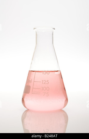 Volumetric flask with pink liquid in experiment in dark room Stock ...