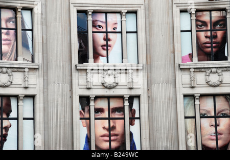 Giant pictures of faces in United Colors of Benetton department store in Oxford Street London Stock Photo