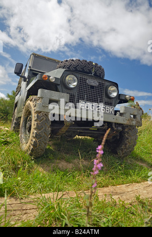 A 1960s Land Rover Lightweight Series 2a with headlamps in the radiator panel driving off road in Bining, France. Stock Photo