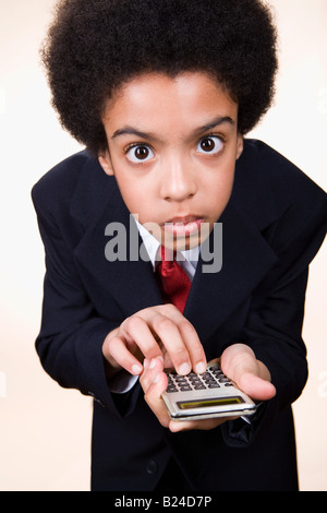 A boy using a calculator Stock Photo