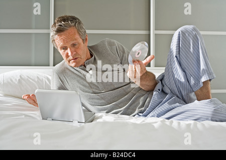 Man with portable dvd player Stock Photo