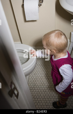 Little girl by toilet Stock Photo