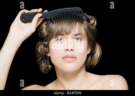 Woman combing hair Stock Photo