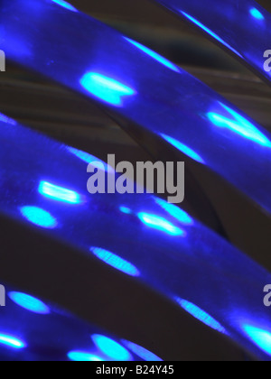 blue laser rays on round cylinder wheel glass Stock Photo