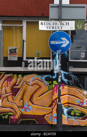 Road sign for Redchurch Street in London On the arrow on a one way sign on the same signpost is a sticker saying impeach Bush Stock Photo