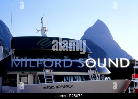 Mitre Peak, Milford Sound, Fiordland, New Zealand, viewed through glass windows of cruise ship terminal, cruise ships foreground Stock Photo