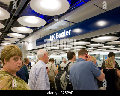 People waiting to go through UK border control at Heathrow terminal 5 airport, London England UK Stock Photo