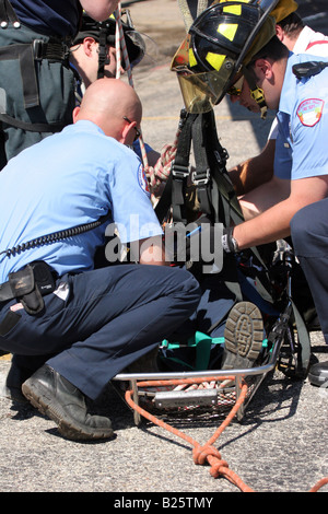 An aerial rescue using a ladder truck with a victim in the basket Stock Photo