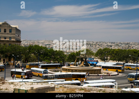 The bus station in Valletta, Malta is located around the Triton Fountain outside of the historic old Three Cities Republic St. Stock Photo