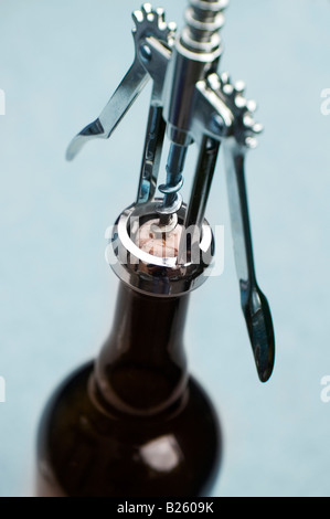 Corkscrew opening wine bottle Stock Photo