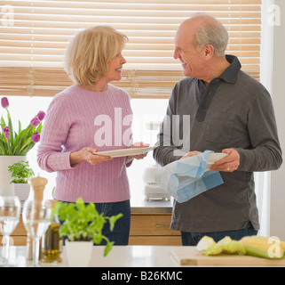 Senior couple drying dishes Stock Photo