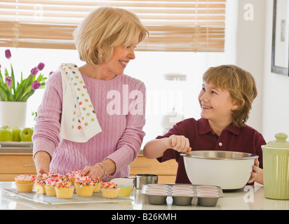 Grandmother and grandson baking cupcakes Stock Photo