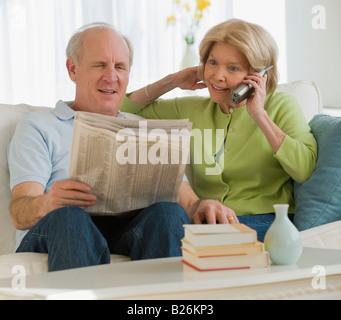 Senior couple relaxing on sofa Stock Photo