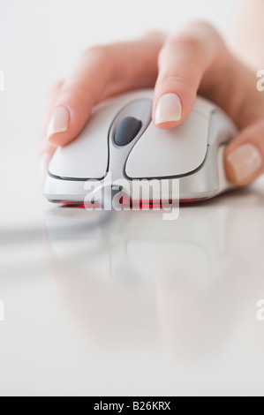 Woman’s hand on computer mouse Stock Photo