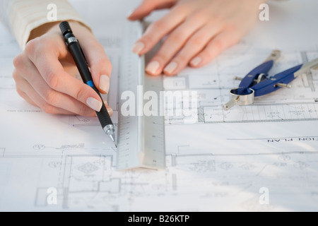 Architect drawing on blueprints Stock Photo