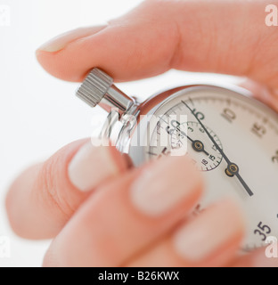 Woman holding stopwatch Stock Photo