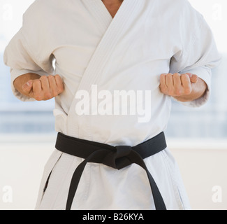 Male karate black belt in fighting stance Stock Photo