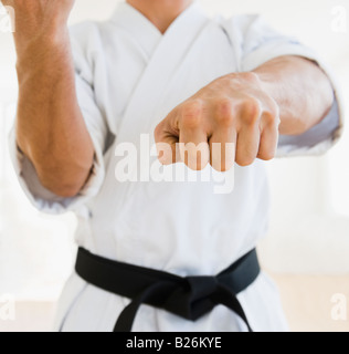 Male karate black belt in fighting stance Stock Photo