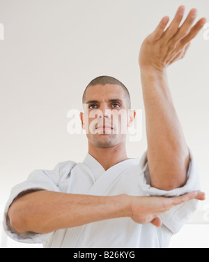 Hispanic man in karate fighting stance Stock Photo