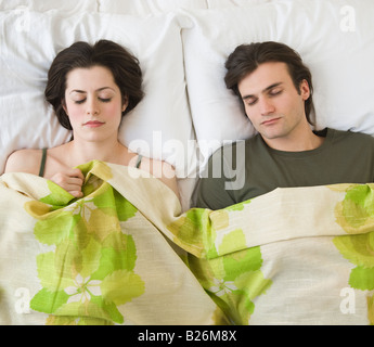 Couple sleeping in bed Stock Photo