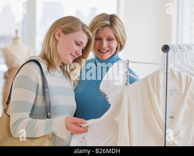 Mother and teen daughter shopping together, at entrance of Lilly Stock