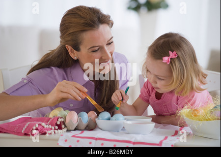Mother and daughter decorating eggs Stock Photo