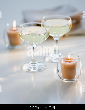 Glasses of champagne next to candles Stock Photo