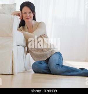 Naked woman sitting on the floor Stock Photo - Alamy